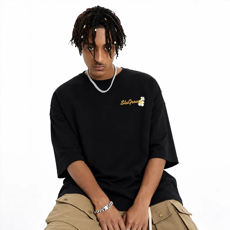 Oversized black T-shirt with a small embroidered chest logo