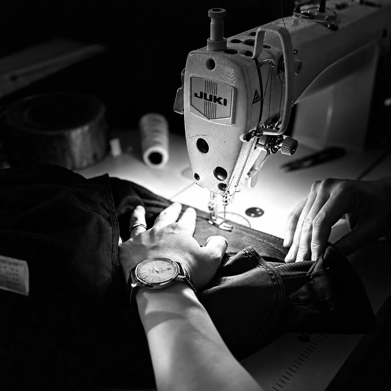 Operator sewing a garment with an industrial sewing machine